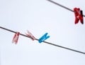 Colored plastic clothespins hanging on the clothesline on