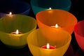 Colored plastic cups with candles Royalty Free Stock Photo