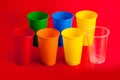 Colored plastic glasses on red background Royalty Free Stock Photo