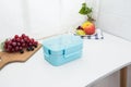 Colored plastic lunchboxes on the table