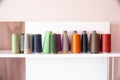 colored polyester threads in the sewing house. Ready-to-sew nylon threads Royalty Free Stock Photo