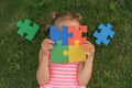 Colored puzzle made of elements in the hands of child suffering from autism Royalty Free Stock Photo