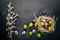 Colored quail eggs. Black wooden background.