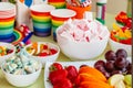 Colored rainbow candybar, sweets and fruits of bright colors on table Royalty Free Stock Photo