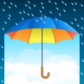 Colored realistic umbrella. Open umbrella on rain and blue sky