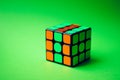 Colored rubik\'s cube on a green background Royalty Free Stock Photo