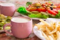 Colored salad and frensh fries with Pickled Cucumber on white plates