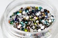 colored sequins in a plastic jar close-up Royalty Free Stock Photo