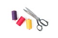 Colored sewing thread coils with old metal scissors on white background Royalty Free Stock Photo