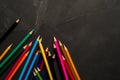 Colored sharpened pencils lie on the dark surface Royalty Free Stock Photo