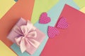 Colored sheets of paper decorative heart Valentine's day gift box ribbon satin bow pink. Royalty Free Stock Photo