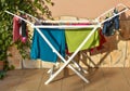 colored shirts, socks, pijamas, t-shirts, underpants, gloves and other clothes wet after being washed, hold in a washing line at Royalty Free Stock Photo
