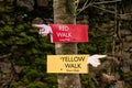 Colored signs for the red and yellow walking trail in the park Royalty Free Stock Photo