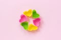 Colored silicone heart shaped molds dish for baking cupcakes on pink paper background. Template for lettering, text or your design