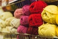 Colored skeins of wool on a store shelf. Woolen skeins for knitting all the colors of the rainbow, beige, pink, red and purple Royalty Free Stock Photo