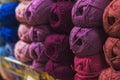 Colored skeins of wool on a store shelf. Woolen skeins for knitting all the colors of the rainbow, blue, brown, red and purple Royalty Free Stock Photo