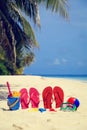 Colored slippers, toys and diving mask at beach Royalty Free Stock Photo