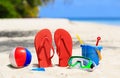 Colored slippers, toys and diving mask at beach Royalty Free Stock Photo