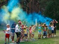 Colored smoke and children. Bright blue and yellow party smoke. Birthday or party