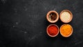 Colored spices on a black stone background. Free space for your text. Royalty Free Stock Photo