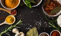 Colored spices with herbs on stone