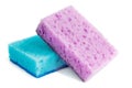 Colored sponges for washing dishes and other domestic needs. The purple sponge lies on the blue at a slight angle. Isolate