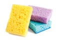 Colored sponges for washing dishes and other domestic needs. Yellow, blue and purple sponges are located next to each other.