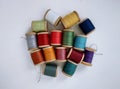 Colored spools of sewing thread on a white background top view.Sewing masks,clothes,multi-colored rainbow-colored threads.Small Royalty Free Stock Photo