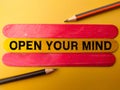 Colored stick and pencil with the word OPEN YOUR MIND Royalty Free Stock Photo