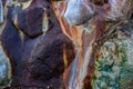 Colored stone surface closeup photo with wet stain. Stone wall texture for natural rustic background. Grungy stone wall Royalty Free Stock Photo