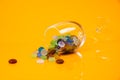 colored stones in glass in jar in bucket on orange background Royalty Free Stock Photo