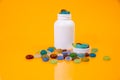 colored stones in glass in jar in bucket on orange background Royalty Free Stock Photo