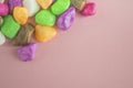 Colored stones, on a pink background, top view, lying on a flat surface Royalty Free Stock Photo