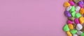 Colored stones, on a pink background, top view, lying on a flat surface, banner Royalty Free Stock Photo