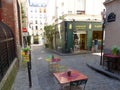 Colored tables and chairs on the street in Montmartre to Paris in France. Royalty Free Stock Photo