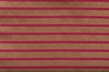 Colored striped coarse linen fabric closeup as background. Red-golden fabric striped texture pattern