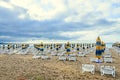 Colored stripped sun umbrellas, golden beach sand and sunbeds