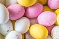 Colored sweet little eggs. Multi-colored Easter eggs on a plate. Sweet Easter eggs shot close up. Festive chocolate eggs in pink,