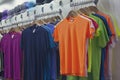 Colored T-shirts and caps in the store Royalty Free Stock Photo