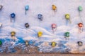 Colored telephones hanging in a blue and white wall