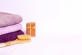 Colored terry towels, a wooden brush for dry massage, soap on a white background Royalty Free Stock Photo