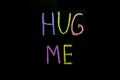 Colored text hug me drawned on chalkboard