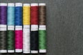 Colored thread coils on black background