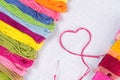 Colored thread for embroidery on white canvas. The concept of love for a hobby. Royalty Free Stock Photo