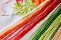 Colored threads for embroidery on a embroidered canvas. Royalty Free Stock Photo