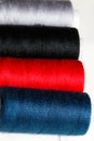 Colored threads and needles. Everything you need for sewing. Several spools of thread. Sharp needles.Red, black, gray and blue thr Royalty Free Stock Photo