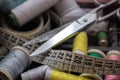 Colored threads, scissors and tape measure. Objects needed for a tailor. Royalty Free Stock Photo