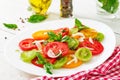 Colored tomato salad with onion and basil pesto. Royalty Free Stock Photo