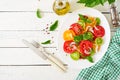 Colored tomato salad with onion and basil pesto. Royalty Free Stock Photo