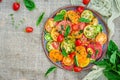 Colored tomato salad with onion and basil. Vegan food.